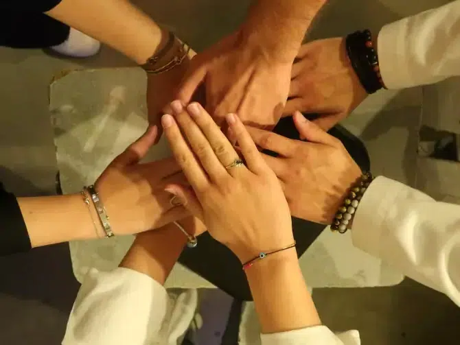 Les mains d’une équipe réunies au centre